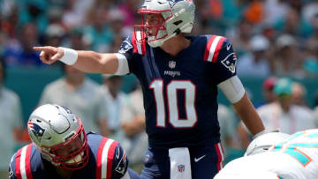 MIAMI GARDENS, FLORIDA - SEPTEMBER 11: Mac Jones #10 of the New England Patriots gestures at the line of scrimmage during the first half against the Miami Dolphins at Hard Rock Stadium on September 11, 2022 in Miami Gardens, Florida. (Photo by Eric Espada/Getty Images)
