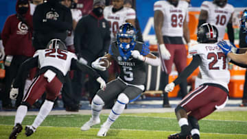 Dec 5, 2020; Lexington, Kentucky, USA; Kentucky Wildcats wide receiver Michael Drennen II runs between South Carolina Gamecocks defensive back O'Donnell Fortune (25) and defensive back Jaylan Foster (27) during the third quarter at Kroger Field. Mandatory Credit: Arden Barnes-USA TODAY Sports
