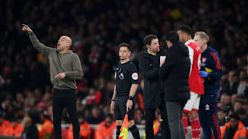 LONDON, ENGLAND - FEBRUARY 15: Pep Guardiola, Manager of Manchester City, reacts as Gabriel of Arsenal speaks with Mikel Arteta, Manager of Arsenal, during the Premier League match between Arsenal FC and Manchester City at Emirates Stadium on February 15, 2023 in London, England. (Photo by Shaun Botterill/Getty Images)
