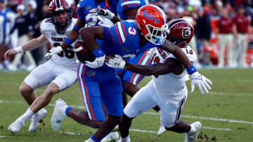 Nov 12, 2022; Gainesville, Florida, USA; South Carolina Gamecocks wide receiver Jalen Brooks (13) causes Florida Gators wide receiver Xzavier Henderson (3) to fumble the ball on special teams during the first quarter at Ben Hill Griffin Stadium. Mandatory Credit: Kim Klement-USA TODAY Sports
