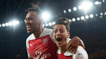LONDON, ENGLAND - OCTOBER 22: Pierre-Emerick Aubamayang of Arsenal celebrates with Mesut Ozil after scoring Arsenal's third goal during the Premier League match between Arsenal FC and Leicester City at the Emirates Stadium on October 22, 2018 in London, United Kingdom. (Photo by Visionhaus/Getty Images)