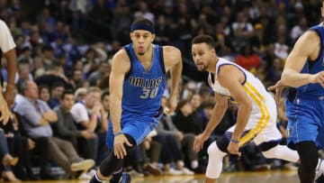 OAKLAND, CA - DECEMBER 30: Seth Curry #30 of the Dallas Mavericks dribbles past his brother Stephen Curry #30 of the Golden State Warriors at ORACLE Arena on December 30, 2016 in Oakland, California. NOTE TO USER: User expressly acknowledges and agrees that, by downloading and or using this photograph, User is consenting to the terms and conditions of the Getty Images License Agreement. (Photo by Ezra Shaw/Getty Images)