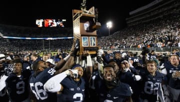Nov 26, 2016; University Park, PA, USA; Penn State Nittany Lions football players carry the Land-Grant trophy following the competition of the game at Beaver Stadium. Penn State defeated Michigan State 45-12. Mandatory Credit: Matthew O