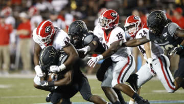NASHVILLE, TN - AUGUST 31: Travon Walker #44 and Trezmen Marshall #15 of the Georgia Bulldogs tackle Jamauri Wakefield #32 of the Vanderbilt Commodores during a game at Vanderbilt Stadium on August 31, 2019 in Nashville, Tennessee. Georgia defeated Vanderbilt 30-6. (Photo by Joe Robbins/Getty Images)
