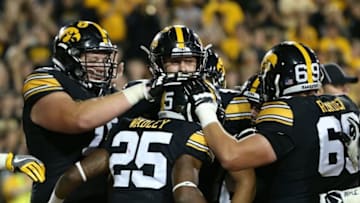 Sep 10, 2016; Iowa City, IA, USA; Iowa Hawkeyes running back Akrum Wadley (25) is swarmed by teammates after scoring a touchdown against the Iowa State Cyclones at Kinnick Stadium. The Hawkeyes beat the Cyclones 42-3. Mandatory Credit: Reese Strickland-USA TODAY Sports
