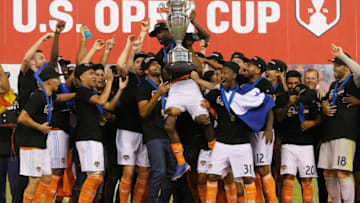 HOUSTON, TX - SEPTEMBER 26: DaMarcus Beasley #7 of Houston Dynamo lifts up the championship trophy after defeating the Philadelphia Union 3-0 during the 2018 Lamar Hunt U.S. Open Cup final at BBVA Compass Stadium on September 26, 2018 in Houston, Texas. (Photo by Bob Levey/Getty Images)