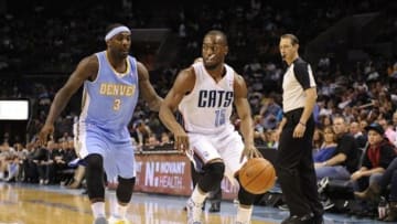 Mar 10, 2014; Charlotte, NC, USA; Charlotte Bobcats guard Kemba Walker (15) drives past Denver Nuggets guard Ty Lawson (3) during the second half of the game at Time Warner Cable Arena. Bobcats win 105-98. Mandatory Credit: Sam Sharpe-USA TODAY Sports