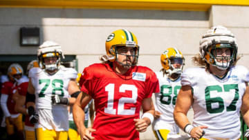 Green Bay Packers quarterback Aaron Rodgers (12) runs onto the practice field with teammates, tackle/guard Cole Van Lanen (78), wide receiver Juwann Winfree (88) and center Jake Hanson (67) during training camp on Tuesday, Aug. 2, 2022, at Ray Nitschke Field in Ashwaubenon, Wis. Samantha Madar/USA TODAY NETWORK-Wis.Gpg Packers Training Camp 08022022 0008