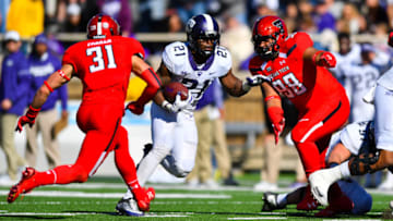 LUBBOCK, TX - NOVEMBER 18: Kyle Hicks #21 of the TCU Horned Frogs goes between two Texas Tech Red Raider defenders during the game between the Texas Tech Red Raiders and the TCU Horned Frogs on November 18, 2017 at Jones AT&T Stadium in Lubbock, Texas. TCU defeated Texas Tech 27-3. (Photo by John Weast/Getty Images)
