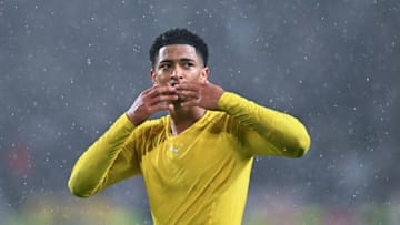 STUTTGART, GERMANY - APRIL 08: Jude Bellingham of Borussia Dortmund celebrates in the rain with the fans after the Bundesliga match between VfB Stuttgart and Borussia Dortmund at Mercedes-Benz Arena on April 08, 2022 in Stuttgart, Germany. (Photo by Helge Prang/GES-Sportfoto/Getty Images)