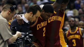 Dec 31, 2013; Indianapolis, IN, USA; Cleveland Cavaliers point guard Kyrie Irving (2) is helped off the court after being injured during the third quarter against the Indiana Pacers at Bankers Life Fieldhouse. The Pacers won 91-76. Mandatory Credit: Pat Lovell-USA TODAY Sports