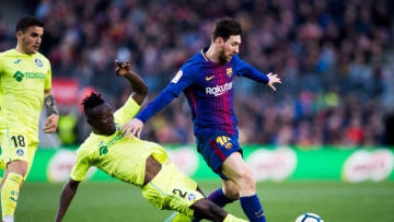 BARCELONA, SPAIN - FEBRUARY 11: Djene Dakonam of Getafe CF tackles Lionel Messi of FC Barcelona during the La Liga match between Barcelona and Getafe at Camp Nou on February 11, 2018 in Barcelona, Spain. (Photo by Alex Caparros/Getty Images)