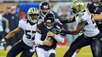 Dec 15, 2014; Chicago, IL, USA; New Orleans Saints inside linebacker David Hawthorne (57) and New Orleans Saints inside linebacker Ramon Humber (53) sack Chicago Bears quarterback Jay Cutler (6) in the first half of their game at Soldier Field. Mandatory Credit: Matt Marton-USA TODAY Sports