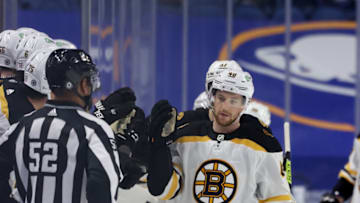 Apr 22, 2021; Buffalo, New York, USA; Boston Bruins defenseman Matt Grzelcyk (48) celebrates his goal with teammates on the bench during the second period against the Buffalo Sabres at KeyBank Center. Mandatory Credit: Timothy T. Ludwig-USA TODAY Sports