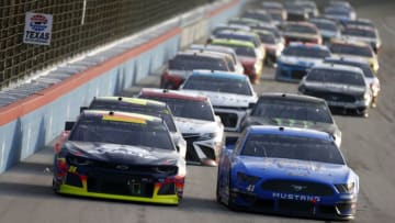 FORT WORTH, TEXAS - NOVEMBER 03: William Byron, driver of the #24 Axalta Chevrolet, and Daniel Suarez, driver of the #41 Walmart Family Mobile Ford, lead the field during the Monster Energy NASCAR Cup Series AAA Texas 500 at Texas Motor Speedway on November 03, 2019 in Fort Worth, Texas. (Photo by Jonathan Ferrey/Getty Images)