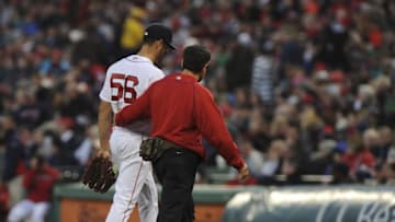 Apr 19, 2016; Boston, MA, USA; Boston Red Sox starting pitcher Joe Kelly (56) walks off the mound with a member of the training staff during the first inning against the Tampa Bay Rays at Fenway Park. Mandatory Credit: Bob DeChiara-USA TODAY Sports