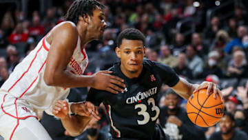 Cincinnati Bearcats forward Ody Oguama dribbles against Houston Cougars center Josh Carlton at Fifth Third Arena. USA Today.