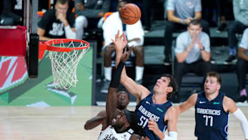 Aug 23, 2020; Lake Buena Vista, Florida, USA; Dallas Mavericks' Boban Marjanovic (51) and Los Angeles Clippers' Montrezl Harrell (5) reach for a rebound during the first half at AdventHealth Arena. Mandatory Credit: Ashley Landis/Pool Photo-USA TODAY Sports