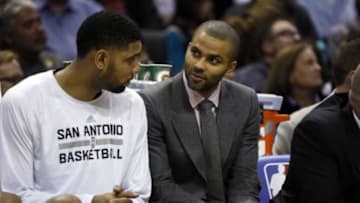 Dec 19, 2014; San Antonio, TX, USA; San Antonio Spurs power forward Tim Duncan ( L) talks with Tony Parker (R) during the second half against the Portland Trail Blazers at AT&T Center. Mandatory Credit: Soobum Im-USA TODAY Sports