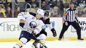 Mar 29, 2016; Pittsburgh, PA, USA; Buffalo Sabres left wing Marcus Foligno (82) skates with the puck as Pittsburgh Penguins center Nick Bonino (13) defends in overtime at the CONSOL Energy Center. The Penguins won 5-4 in a shootout. Mandatory Credit: Charles LeClaire-USA TODAY Sports