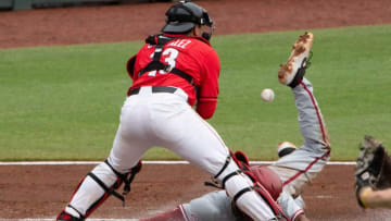 May 24, 2022; Hoover, AL, USA; Alabama outfielder Andrew Pinckney (21) scores on a sacrifice fly as Georgia catcher Fernando Gonzalez takes the throw too late. Alabama faced Georgia in game one of the SEC Tournament at Hoover Met. Mandatory Credit: Gary Cosby Jr.-The Tuscaloosa NewsNcaa Baseball Sec Baseball Tournament Alabama Crimson Tide At Georgia Bulldogs