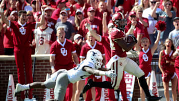 Oct 19, 2019; Norman, OK, USA; Oklahoma Sooners wide receiver Lee Morris (84) catches a touchdown pass past West Virginia Mountaineers safety Tykee Smith (23) during the third quarter at Gaylord Family - Oklahoma Memorial Stadium. Mandatory Credit: Kevin Jairaj-USA TODAY Sports