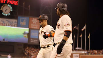 Oct 11, 2016; San Francisco, CA, USA; San Francisco Giants second baseman Joe Panik (12) celebrates hitting a sac fly to score shortstop Brandon Crawford (35) during the fifth inning of game four of the 2016 NLDS playoff baseball game against the Chicago Cubs at AT&T Park. Mandatory Credit: John Hefti-USA TODAY Sports