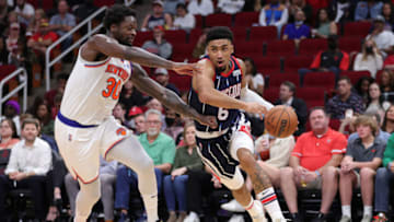 HOUSTON, TEXAS - DECEMBER 16: Kenyon Martin Jr. #6 of the Houston Rockets controls the ball around Julius Randle #30 of the New York Knicks during the second half at Toyota Center on December 16, 2021 in Houston, Texas. NOTE TO USER: User expressly acknowledges and agrees that, by downloading and or using this photograph, User is consenting to the terms and conditions of the Getty Images License Agreement. (Photo by Carmen Mandato/Getty Images)