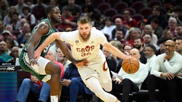 Mar 4, 2023; Cleveland, Ohio, USA; Cleveland Cavaliers forward Dean Wade (32) drives beside Detroit Pistons forward Eugene Omoruyi (97) in the fourth quarter at Rocket Mortgage FieldHouse. Mandatory Credit: David Richard-USA TODAY Sports