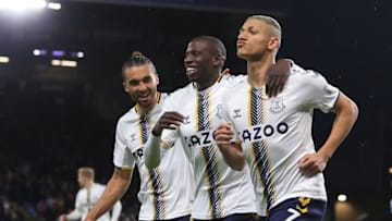 Everton's Brazilian striker Richarlison (R) celebrates with Everton's French midfielder Abdoulaye Doucoure (C) and Everton's English striker Dominic Calvert-Lewin (L) after scoring his second goal from the penalty spot during the English Premier League football match between Burnley and Everton at Turf Moor in Burnley, north west England on April 6, 2022. - RESTRICTED TO EDITORIAL USE. No use with unauthorized audio, video, data, fixture lists, club/league logos or 'live' services. Online in-match use limited to 120 images. An additional 40 images may be used in extra time. No video emulation. Social media in-match use limited to 120 images. An additional 40 images may be used in extra time. No use in betting publications, games or single club/league/player publications. (Photo by Lindsey Parnaby / AFP) / RESTRICTED TO EDITORIAL USE. No use with unauthorized audio, video, data, fixture lists, club/league logos or 'live' services. Online in-match use limited to 120 images. An additional 40 images may be used in extra time. No video emulation. Social media in-match use limited to 120 images. An additional 40 images may be used in extra time. No use in betting publications, games or single club/league/player publications. / RESTRICTED TO EDITORIAL USE. No use with unauthorized audio, video, data, fixture lists, club/league logos or 'live' services. Online in-match use limited to 120 images. An additional 40 images may be used in extra time. No video emulation. Social media in-match use limited to 120 images. An additional 40 images may be used in extra time. No use in betting publications, games or single club/league/player publications. (Photo by LINDSEY PARNABY/AFP via Getty Images)