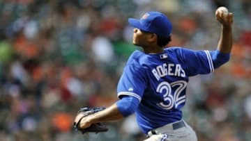 Apr 13, 2014; Baltimore, MD, USA; Toronto Blue Jays pitcher Esmil Rogers (32) throws the ball in the eighth inning against the Baltimore Orioles at Oriole Park at Camden Yards. The Blue Jays won 11-3. Mandatory Credit: Joy R. Absalon-USA TODAY Sports