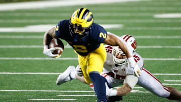 Nov 14, 2020; Ann Arbor, Michigan, USA; Michigan Wolverines running back Blake Corum (2) breaks a tackle by Wisconsin Badgers linebacker Leo Chenal (45) in the first half at Michigan Stadium. Mandatory Credit: Rick Osentoski-USA TODAY Sports