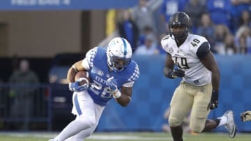 Oct 8, 2016; Lexington, KY, USA; Kentucky Wildcats running back Benny Snell (26) runs the ball against Vanderbilt Commodores defensive Jonathan Wynn (49) in the second half at Commonwealth Stadium. Kentucky defeated Vanderbilt 20-13. Mandatory Credit: Mark Zerof-USA TODAY Sports