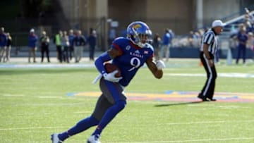 Oct 11, 2014; Lawrence, KS, USA; Kansas Jayhawks wide receiver Nigel King (9) runs after a catch against the Oklahoma State Cowboys in the first half at Memorial Stadium. Mandatory Credit: John Rieger-USA TODAY Sports