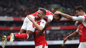 LONDON, ENGLAND - OCTOBER 15: Shkodran Mustafi of Arsenal lifts goalscorer Theo Walcott of Arsenal after he scored his team's second goal during the Premier League match between Arsenal and Swansea City at Emirates Stadium on October 15, 2016 in London, England. (Photo by Julian Finney/Getty Images)