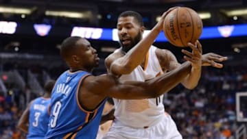 Feb 8, 2016; Phoenix, AZ, USA; Phoenix Suns forward Markieff Morris (11) handles the ball against defender Oklahoma City Thunder forward Serge Ibaka (9) at Talking Stick Resort Arena. Oklahoma City won 122- 106. Mandatory Credit: Jennifer Stewart-USA TODAY Sports