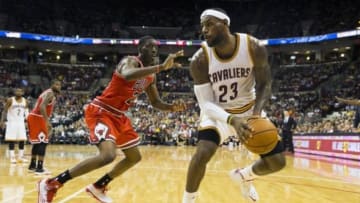 Oct 20, 2014; Columbus, OH, USA; Cleveland Cavaliers forward LeBron James (23) spins past Chicago Bulls forward Tony Snell (20) at Value City Arena. Cleveland won the game 107-98. Mandatory Credit: Greg Bartram-USA TODAY Sports