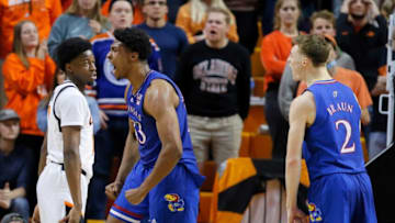 Kansas forward David McCormack (33) celebrates with Christian Braun (2) beside Oklahoma State guard Bryce Williams (14) during the Jayhawks' 74-63 win Tuesday in Stillwater.osu1