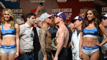 Nov 20, 2015; Las Vegas, NV, USA; Miguel Cotto (left) and Canelo Alvarez (right) pose for a photo during weigh-ins for their upcoming WBC middleweight title fight at Mandalay Bay. Mandatory Credit: Joe Camporeale-USA TODAY Sports