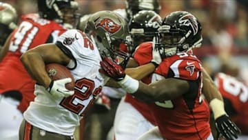 Oct 20, 2013; Atlanta, GA, USA; Tampa Bay Buccaneers running back Doug Martin (22) stiff arms Atlanta Falcons linebacker Joplo Bartu (59) in the first half at the Georgia Dome. Mandatory Credit: Daniel Shirey-USA TODAY Sports