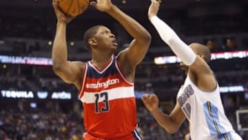 Jan 25, 2015; Denver, CO, USA; Washington Wizards center Kevin Seraphin (13) shoots the ball against Denver Nuggets guard Arron Afflalo (10) during the second half at Pepsi Center. The Wizards won 117-115. Mandatory Credit: Chris Humphreys-USA TODAY Sports
