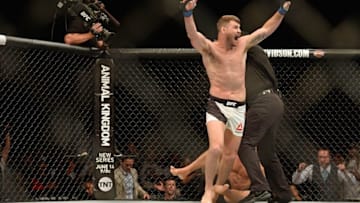 Jun 4, 2016; Los Angeles, CA, USA; Michael Bisping (blue) celebrates his first round knockout of Luke Rockhold (red) during UFC 199 at The Forum. Mandatory Credit: Jake Roth-USA TODAY Sports