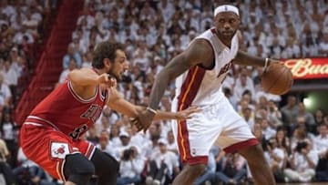 May 6, 2013; Miami, FL, USA; Miami Heat small forward LeBron James (6) dribbles as Chicago Bulls shooting guard Marco Belinelli (8) defends during the second half in game one of the second round of the 2013 NBA Playoffs at American Airlines Arena. The Bulls won 93-86. Mandatory Credit: Steve Mitchell-USA TODAY Sports