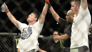 Apr 25, 2015; Montreal, Quebec, CAN; Michael Bisping (red) has his hand raised after defeating CB Dalloway (blue) during their middleweight bout during UFC 186 at Bell Centre. Mandatory Credit: Eric Bolte-USA TODAY Sports