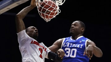 INDIANAPOLIS, IN - MARCH 28: Russ Smith #2 of the Louisville Cardinals dunks the ball over Julius Randle #30 of the Kentucky Wildcats during the regional semifinal of the 2014 NCAA Men's Basketball Tournament at Lucas Oil Stadium on March 28, 2014 in Indianapolis, Indiana. (Photo by Jonathan Daniel/Getty Images)