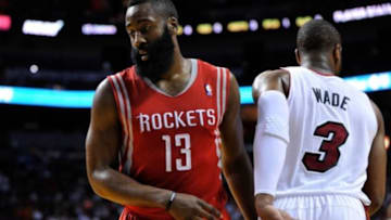 Mar 16, 2014; Miami, FL, USA; Houston Rockets guard James Harden (13) passes by Miami Heat guard Dwyane Wade (3) during the second half at American Airlines Arena. Mandatory Credit: Steve Mitchell-USA TODAY Sports