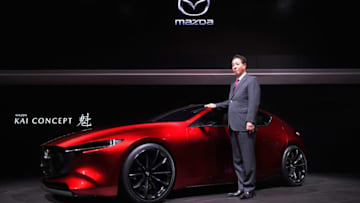 TOKYO, JAPAN - OCTOBER 25: Mazda Motor Co CEO Masamichi Kogai poses with Mazda Kai Concept during a press conference at the Mazda Motor Co booth during the Tokyo Motor Show at Tokyo Big Sight on October 25, 2017 in Tokyo, Japan. (Photo by Koki Nagahama/Getty Images for Mazda Motor Co)
