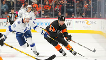 PHILADELPHIA, PA - DECEMBER 05: Scott Laughton #21 of the Philadelphia Flyers controls the puck against Steven Stamkos #91 of the Tampa Bay Lightning at the Wells Fargo Center on December 5, 2021 in Philadelphia, Pennsylvania. The Tampa Bay Lightning defeated the Philadelphia Flyers 7-1. (Photo by Mitchell Leff/Getty Images)