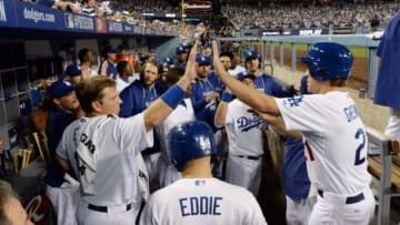 October 4, 2014; Los Angeles, CA, USA; Los Angeles Dodgers starting pitcher Zack Greinke (21) is congratulated after scoring a run in the third inning against the St. Louis Cardinals in game two of the 2014 NLDS playoff baseball game at Dodger Stadium. Mandatory Credit: Jayne Kamin-Oncea-USA TODAY Sports