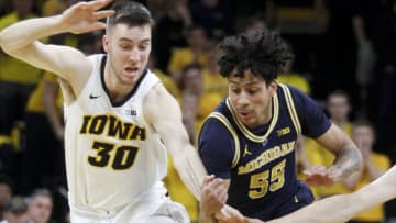 IOWA CITY, IOWA- FEBRUARY 01: Guard Eli Brooks #55 of the Michigan Wolverines chases a loose ball in the first half against guard Connor McCaffery #30 of the Iowa Hawkeyes on February 1, 2019 at Carver-Hawkeye Arena, in Iowa City, Iowa. (Photo by Matthew Holst/Getty Images)